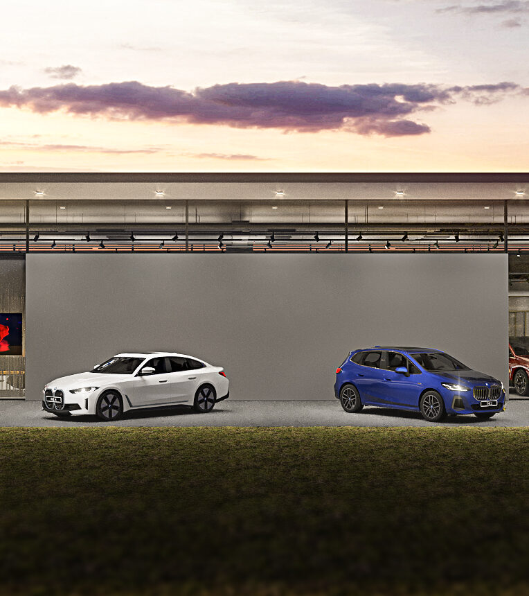 Dusk view of a BMW dealership facade designed to the Retail.Next concept
